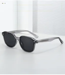 Detail of grey transparent acetate sunglasses frame with metal core and dark lenses