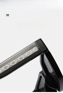 Detail of square black sunglasses showing silver geometric textured metal on the temples