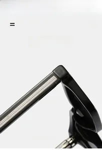 Detail of high-elastic black temple arm on sunglasses showing lightweight texture material