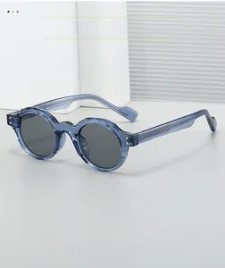 Detail view of transparent blue-gray round frame sunglasses with textured metal temple core