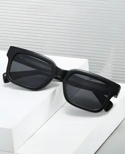 Detail view of black rectangular sunglasses with inner temple texture on geometric stand