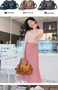 Détail du sac vintage en cuir à poches multiples avec breloque étoile et pompon