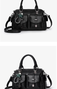 Détail du sac en cuir noir avec poches avant à boucle et pendentif en forme d'étoile