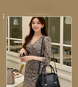 Fashionable black leather square bag with elegant tassels and adjustable shoulder strap