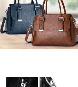 Close-up of silver metal hardware and buckle on a soft leather large crossbody bag