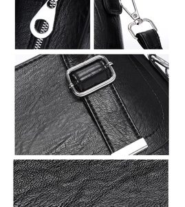 Close-up of litchi grain leather texture and silver hardware on a black crossbody bag