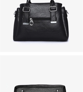 Detail of black pebbled faux leather tote featuring silver metal studs and back zipper