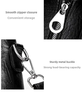 Detail of lychee pattern black leather bag featuring silver metal zipper and D-ring hook