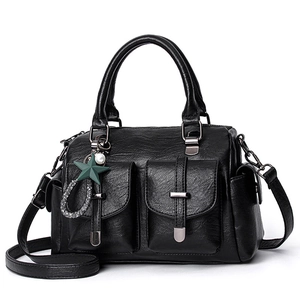Large black leather shoulder bag with dual front pockets and decorative star pendant charm