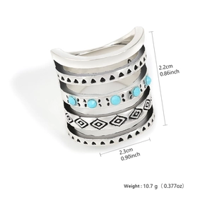 Close-up of vintage bohemian wide band ring with engraved patterns and blue turquoise beads