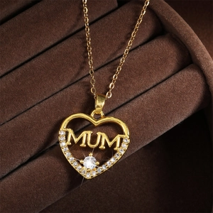 Macro shot of gold heart necklace with MUM lettering and sparkling zircon detail