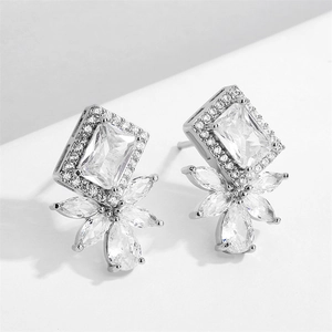 Close-up of geometric square zircon stud earrings with elegant floral drop detail