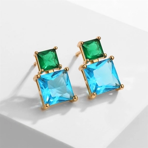 Detailed close-up of geometric square earrings with green and blue cubic zirconia stones