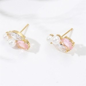 Close-up of curved stud earrings with pearls, pink stones, and marquise zircons