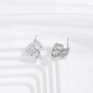 Detailed view of silver curved earrings with pear-cut cubic zirconia in a cluster setting