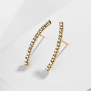 Detailed view of curved gold earrings with sparkling pave-set cubic zirconia stones