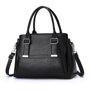 Large black leather tote bag with tassel, dual handles and adjustable shoulder strap
