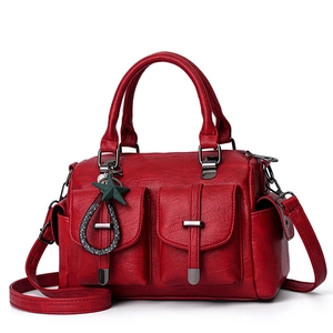 Large red textured leather shoulder bag with top handle and decorative star charm