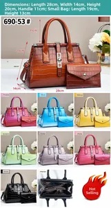 Detailed close-up of crocodile pattern leather texture and set of stylish tote and pouch