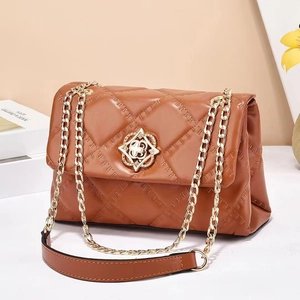 Brown quilted leather crossbody bag with elegant gold floral clasp and chain strap