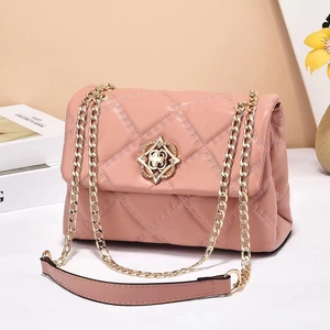 Pink quilted crossbody chain bag with golden floral clasp and faux leather texture