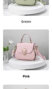 Detail of mint green and pink shell-shaped bags with heart crown metal locks