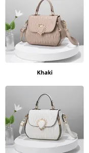 Detail view of shell-shaped shoulder bags with wave quilting and crown heart metal buckle