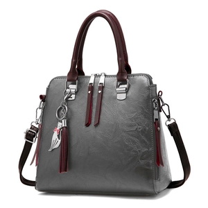 Gray leather handbag with burgundy handles and cute cat pendant charm for women