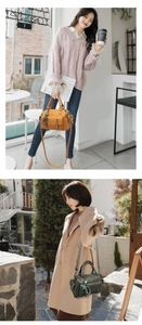 Detail of vintage soft leather handbag with star charm and detachable shoulder strap