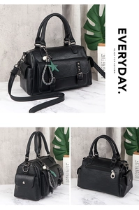 Detail of black faux leather tote bag with multi-pocket design and star charms