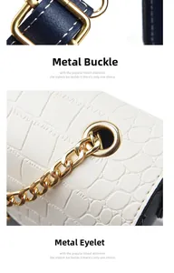 Detail of gold metal hardware buckles and eyelets on a white crocodile embossed leather bag