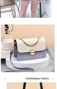 Detail of lavender flap crossbody bag with white crocodile texture and gold chain link