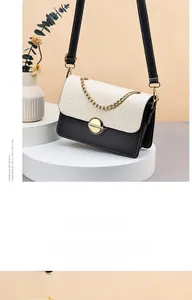 Detail of contrast color mini crossbody bag with crocodile pattern and metal buckle