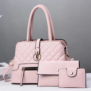 Detailed view of pink three-piece handbag set featuring lattice embossed texture and gold hardware