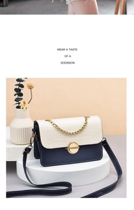 Close-up of contrast color crossbody bag with croc texture on a white pedestal