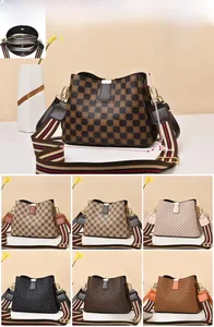 Detail view of checkerboard bucket bags with striped straps and 23cm x 11cm x 18cm dimensions
