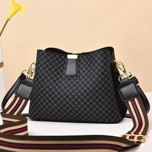 Classic black bucket bag with diamond grid pattern and wide colorful striped shoulder strap