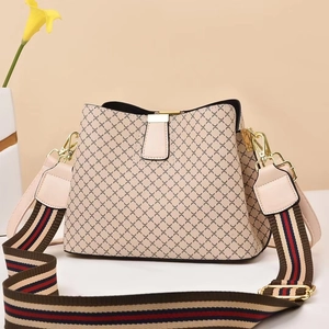 Fashionable beige bucket bag with black geometric diamond pattern and striped wide strap