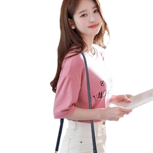 Pink short sleeve T-shirt with black text paired with a black crossbody chain bag