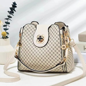 Detail of grid print handbag featuring golden petal twist lock and elegant texture