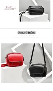 Detail of multi-zipper textured PU leather crossbody bag with white contrast stitching