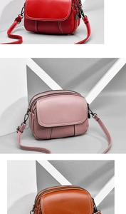 Detailed view showing three zippered layers of the pebbled PU leather crossbody bag