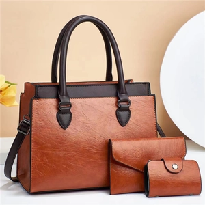 Three-piece retro brown faux leather handbag set with tote, wallet, and card holder