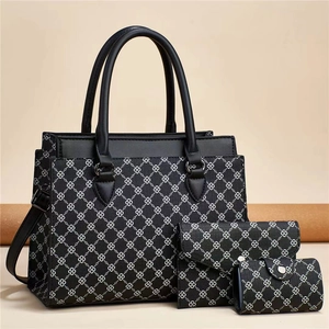 Detailed set of three printed bags featuring a tote, clutch, and coin purse in vintage pattern
