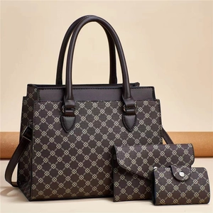 Detailed view of the 3-piece brown tote bag set with geometric patterns and golden hardware