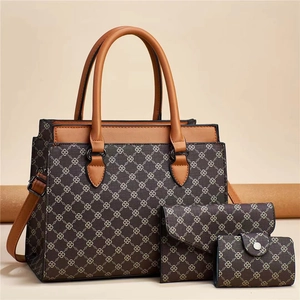 Three-piece printed tote handbag set with crossbody strap and matching clutch in brown and tan