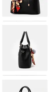 Détail du sac cabas noir à grain de litchi avec poignée en foulard et pompon en fourrure