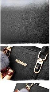 Détail du sac à main noir en cuir PU avec logo doré et accent de foulard en soie