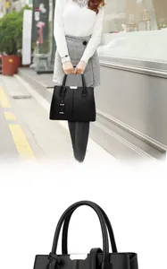 Dettaglio della borsa tote in pelle martellata nera con eleganti finiture in metallo oro chiaro