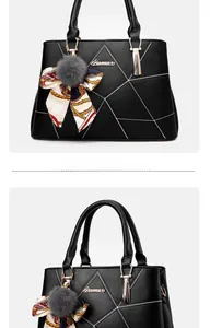 Détail du sac à main noir avec coutures géométriques blanches et pompon décoratif doux